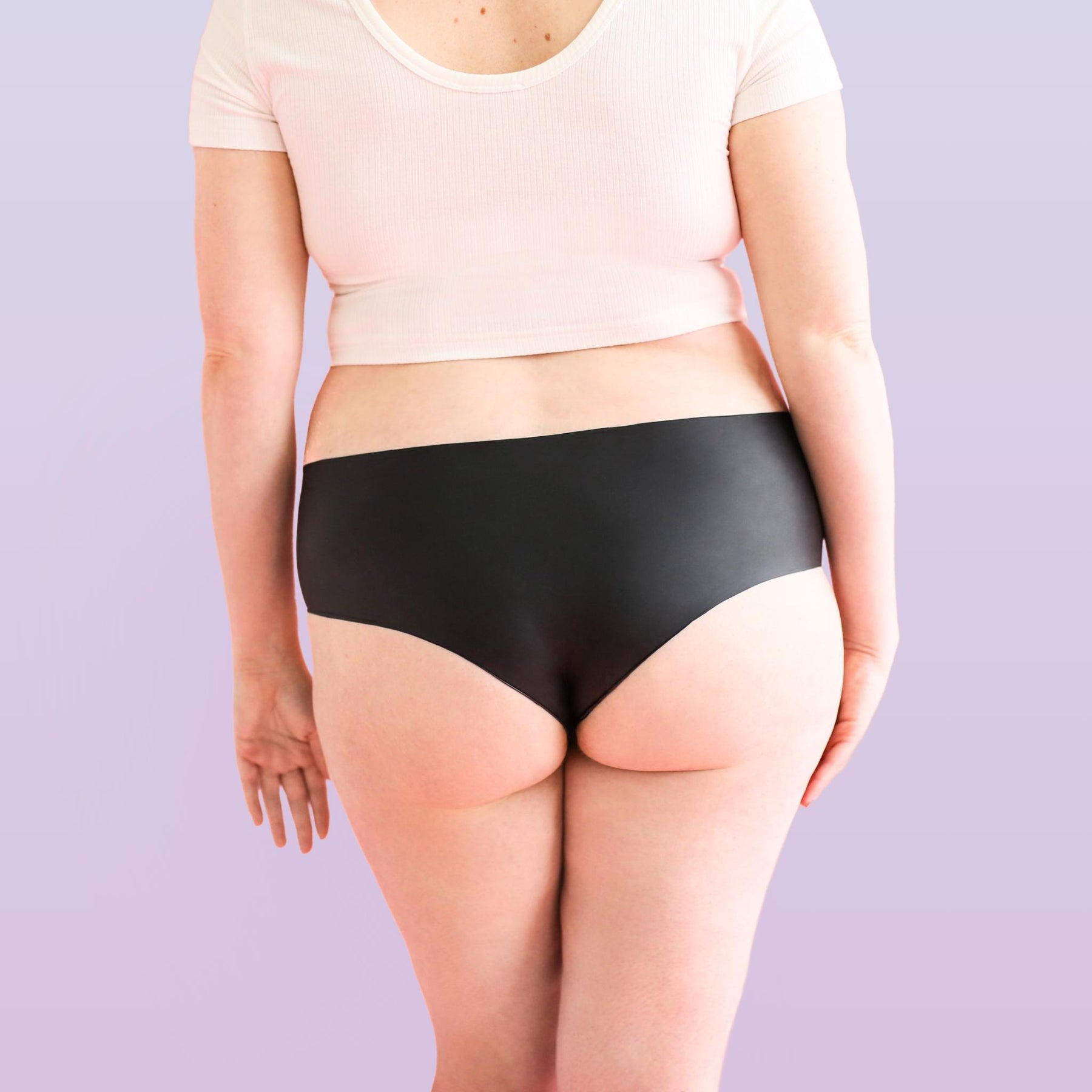 Lorals model Amanda demonstrates the back view of Black Latex STI Protection Panties in Shortie Style