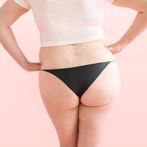 Lorals model Amanda demonstrates the back view of Black Latex Panties in Bikini Style