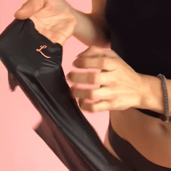 A woman holding Lorals panties and showing the thin lightweight natural rubber latex
